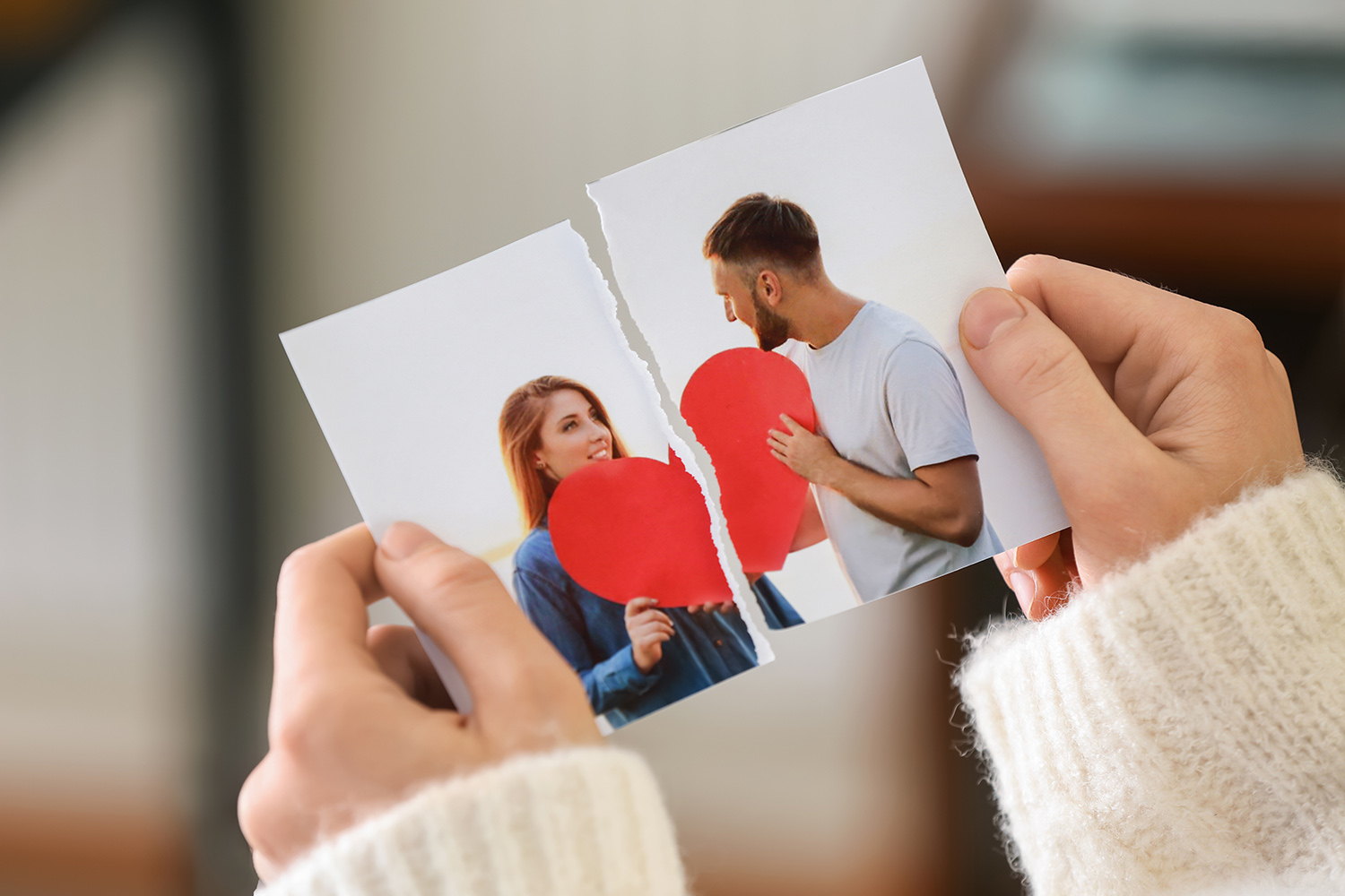Woman tearing up photo of happy couple.